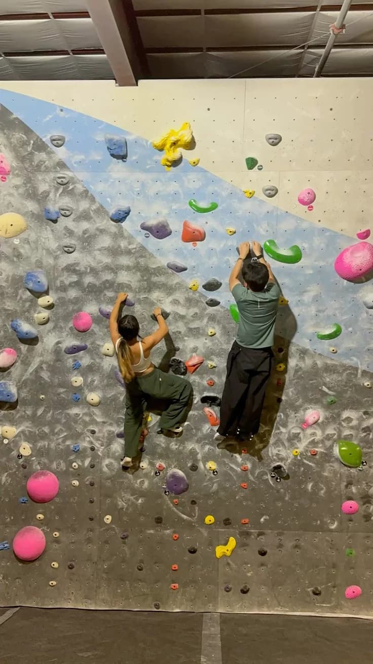Couple rock climbing together